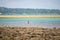 bare backed dark skinned indian fisherman casting net in beautiful arc in the blue green waters of the andaman islands