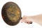 bare caucasian hand holding empty old cast iron frying pan