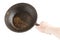 bare caucasian hand holding empty old cast iron frying pan