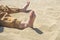 Bare children`s feet on the beach. close-up