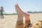 Bare children`s feet on the beach. close-up