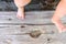 Bare feet of a baby leaning on some old wooden boards