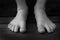 Bare Feet of Child Black and White on Wood Grain Steps