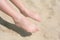 Bare feet of child on sand,