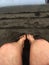 Bare feet on dark sands