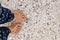 Bare feet of a girl on the sea sand with shells. Top view