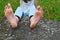 Bare feet of girl on stone