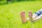 Bare feet on green grass with autumn leaves