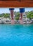 Bare feet hanging from wooden pier sea water. Holiday vacation by the sea