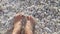 Bare feet laying on the white sand