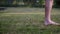 Bare feet of a man on soft grass of lawn