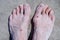 Bare feet of men in the pink salt lake. Salt Deposit. Treatment of wounds with salt.