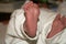 Bare feet of a newborn wrapped in diapers