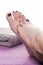 Bare feet with pedicure propped by towel