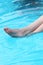 Bare feet of a person relaxing in cool blue water