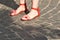 Bare feet in red strap sandals