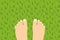 bare feet standing on green grass
