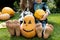 bare feet of two children, spiders sitting on their toes and a painted pumpkin with a grin