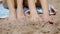 Bare feet of two young women in beach sand