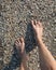 bare feet walking over a carpet of shells
