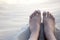Bare feet on warm white sand.