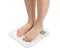 Bare feet on weight scale isolated, overweight control, obese problem, lost weight concept