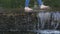 Bare feet of a young girl walking on the water in an artificial pool in the city park