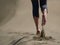 Bare feet of young woman jogging/walking on the beach