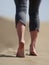 Bare feet of young woman jogging/walking on the beachse