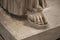 Bare foot of a carved marble statue in the museum there are many hard feet of ancient and historical style in greek art room