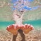 Bare foot child on beach vacation. Underwater photo