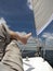 Bare foot of a man who is lying on the deck of the yacht