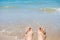 Bare human feet on sand beach