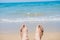 Bare human feet on sand beach