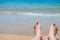 Bare human feet on sand beach