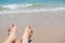 Bare human feet on sand beach