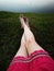 Bare Woman is Feet on The Green Grass. Copy Space. Woman Legs and Feet on Green Grass Near River