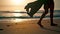 Bare woman legs stepping on wet seashore at sunrise closeup. Girl walking beach.