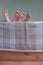 Barefeet of children in wooden bed covered with blanket.