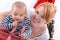 Barefoot baby on white background with his mother on christmas o