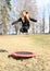 Barefoot blond girl jumping on trampoline