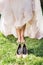 Barefoot bride on grass with shoes