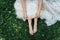 Barefoot bride on grass in summer time