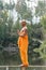 barefoot buddhist standing on wooden fence