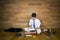 A barefoot businessman after working day sits on the floor