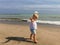 Barefoot child playing on the beach