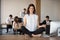 Barefoot employee meditating sitting in lotus position on office