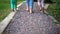 Barefoot family exploring new feelings on feet Wood and small stone path