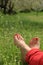 Barefoot female feet on green field