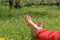 Barefoot female feet on green field